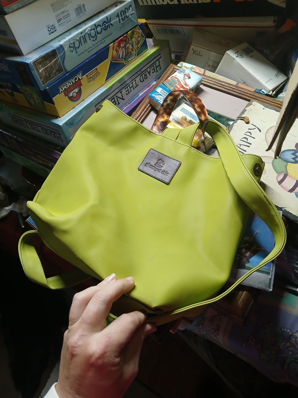 Glenroyal Chic purse features a lime green exterior with a brown leather logo pa